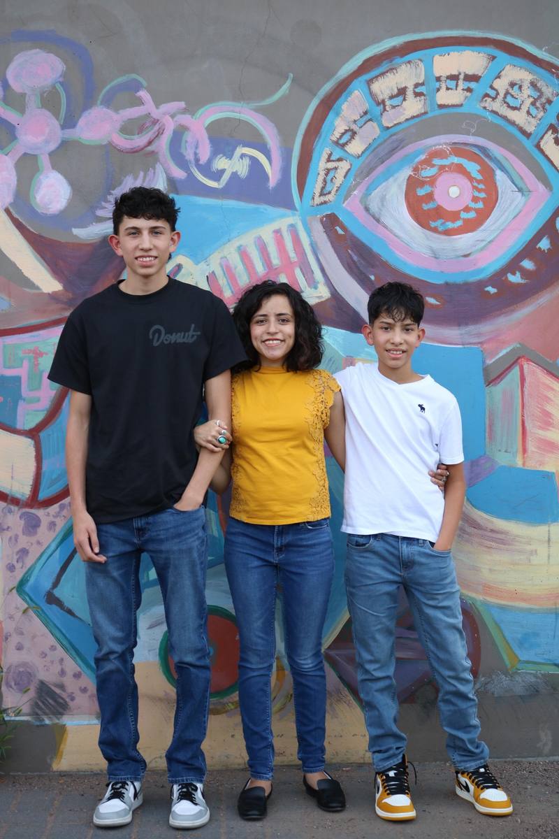 Chase with family in front of a mural