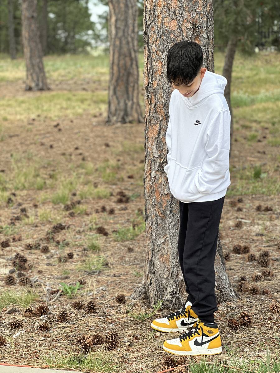 Chase standing among the pines