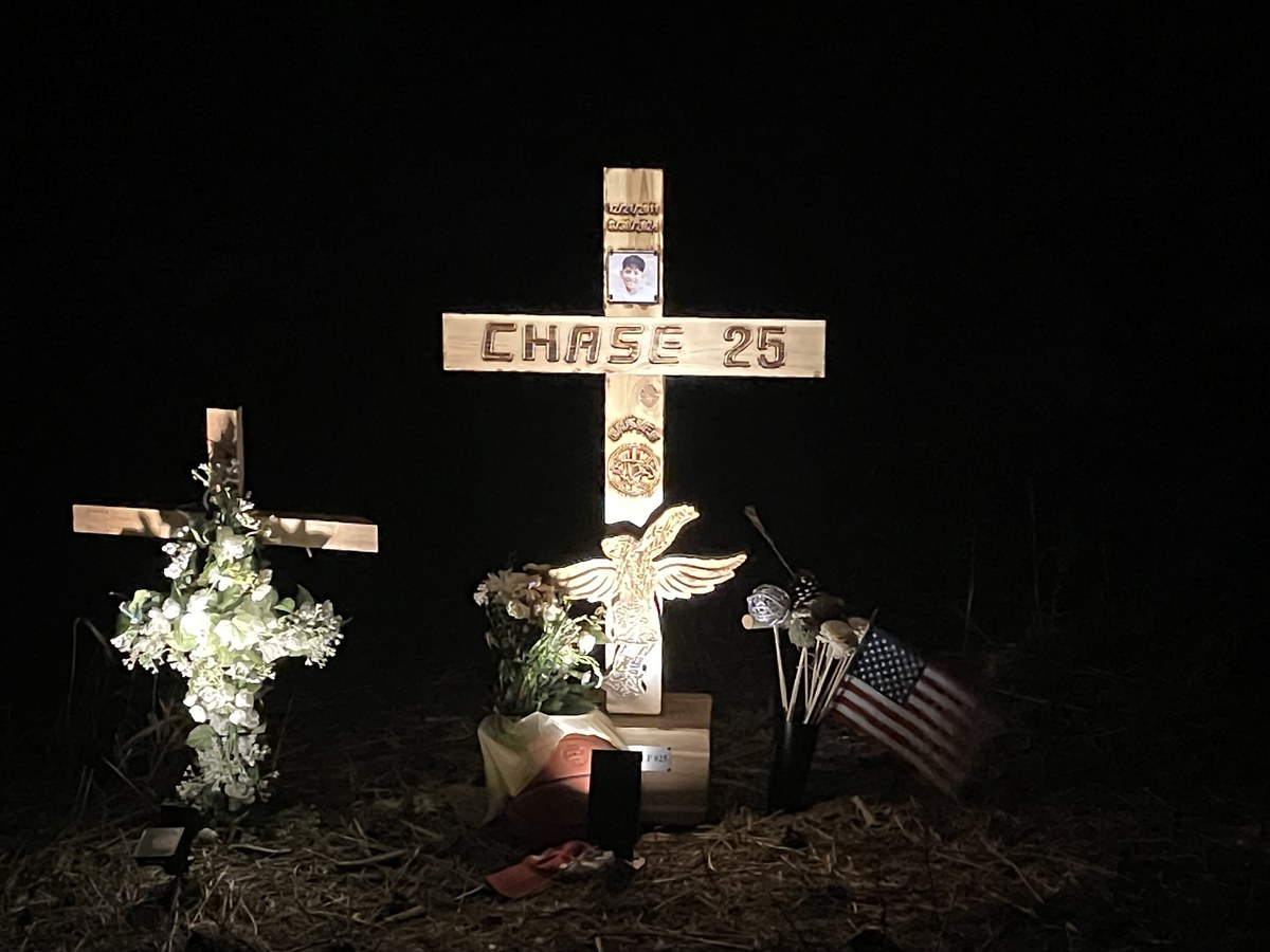 Chase's memorial cross lit up at night