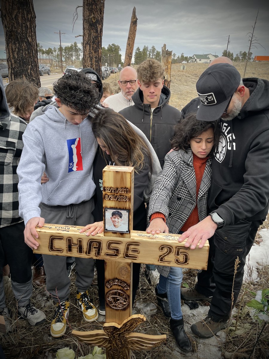 Family gathered around Chase's memorial cross